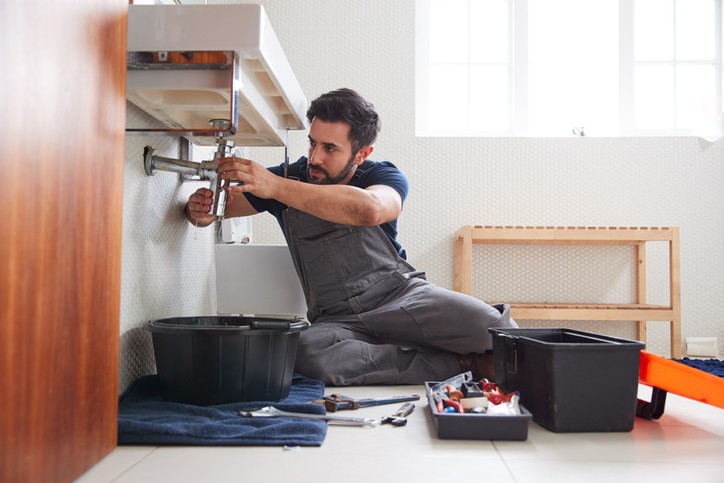 professional plumber repairing bathroom sink