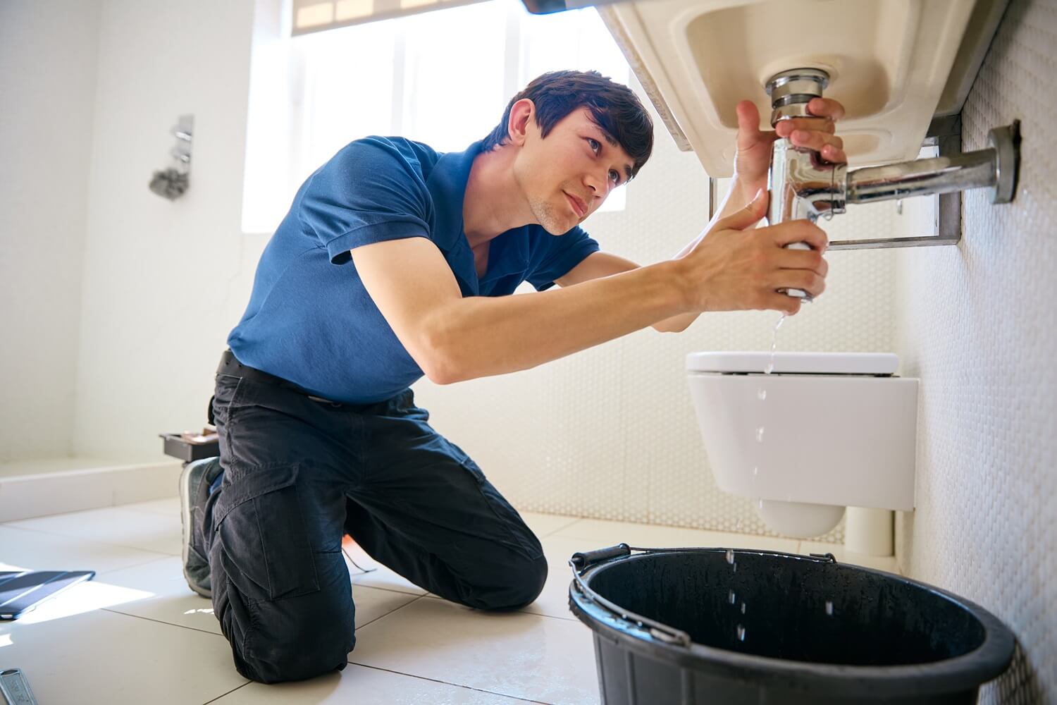 repairing leaky pipe under sink